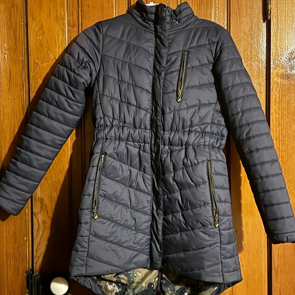 Aubrion mid length, water proof riding coat with fur hood and zipper in back.